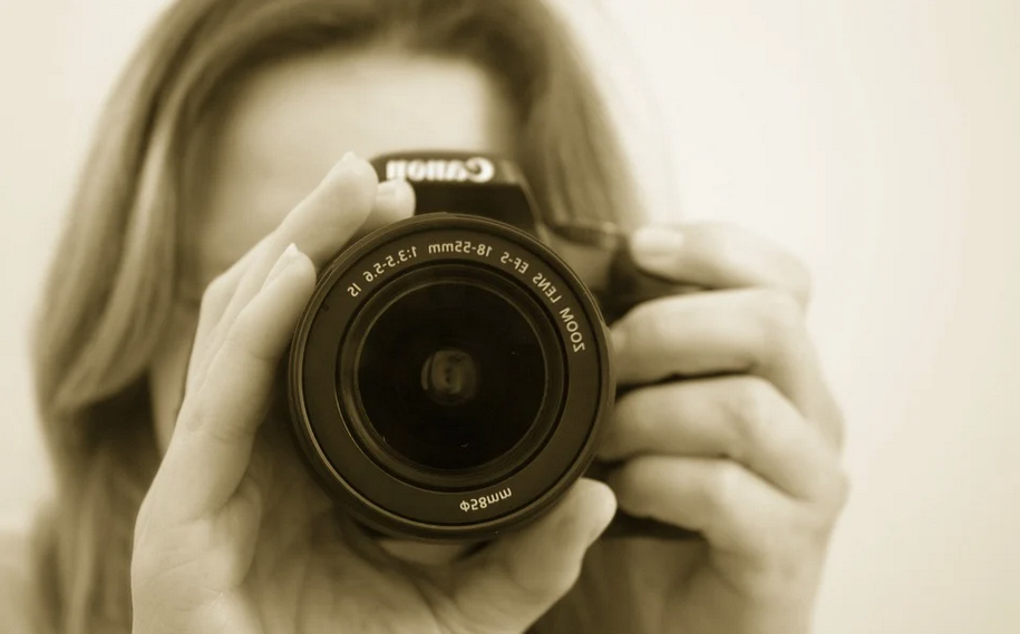 Photographe tenant un appareil photo, illustrant la protection de la photographie par le droit d’auteur.